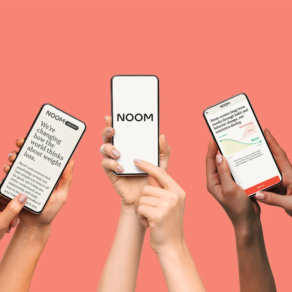 Noom app on phone with healthy foods